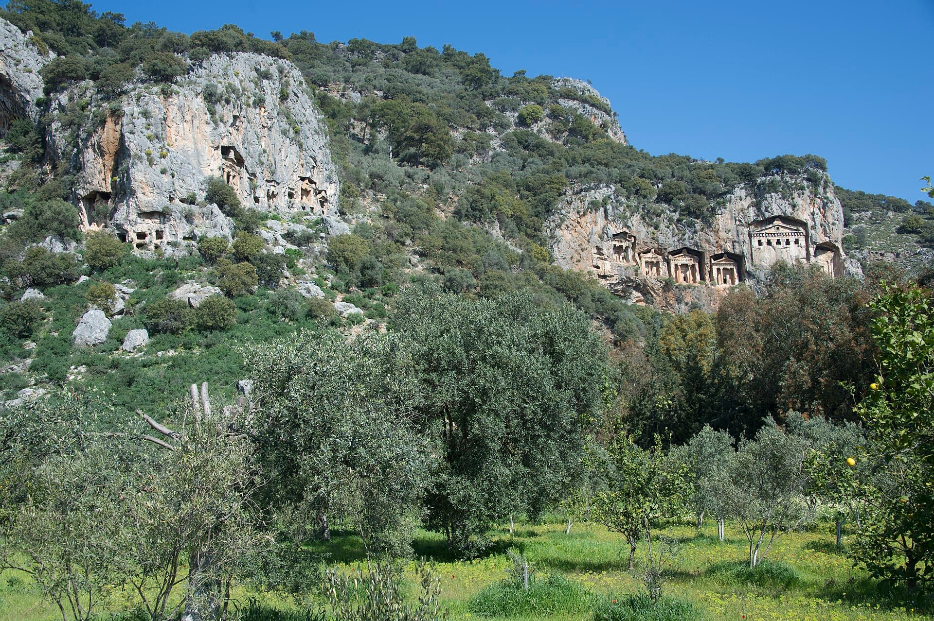 Temple-fronted Lycian rock-cut tombs carved high into the Dalyan cliffside.