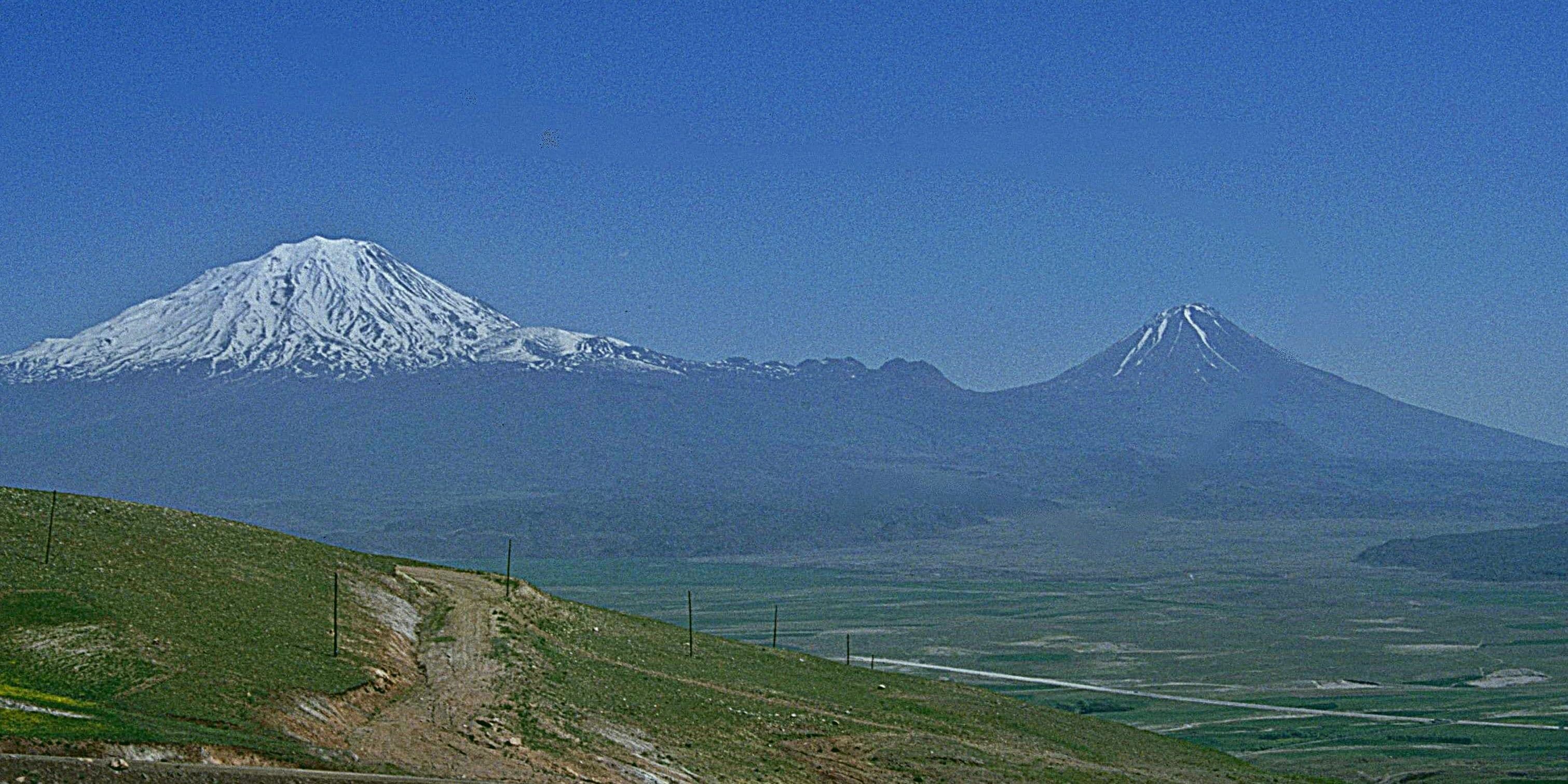 Snow-capped Mount Ararat and Little Ararat's cone peak under a clear sky