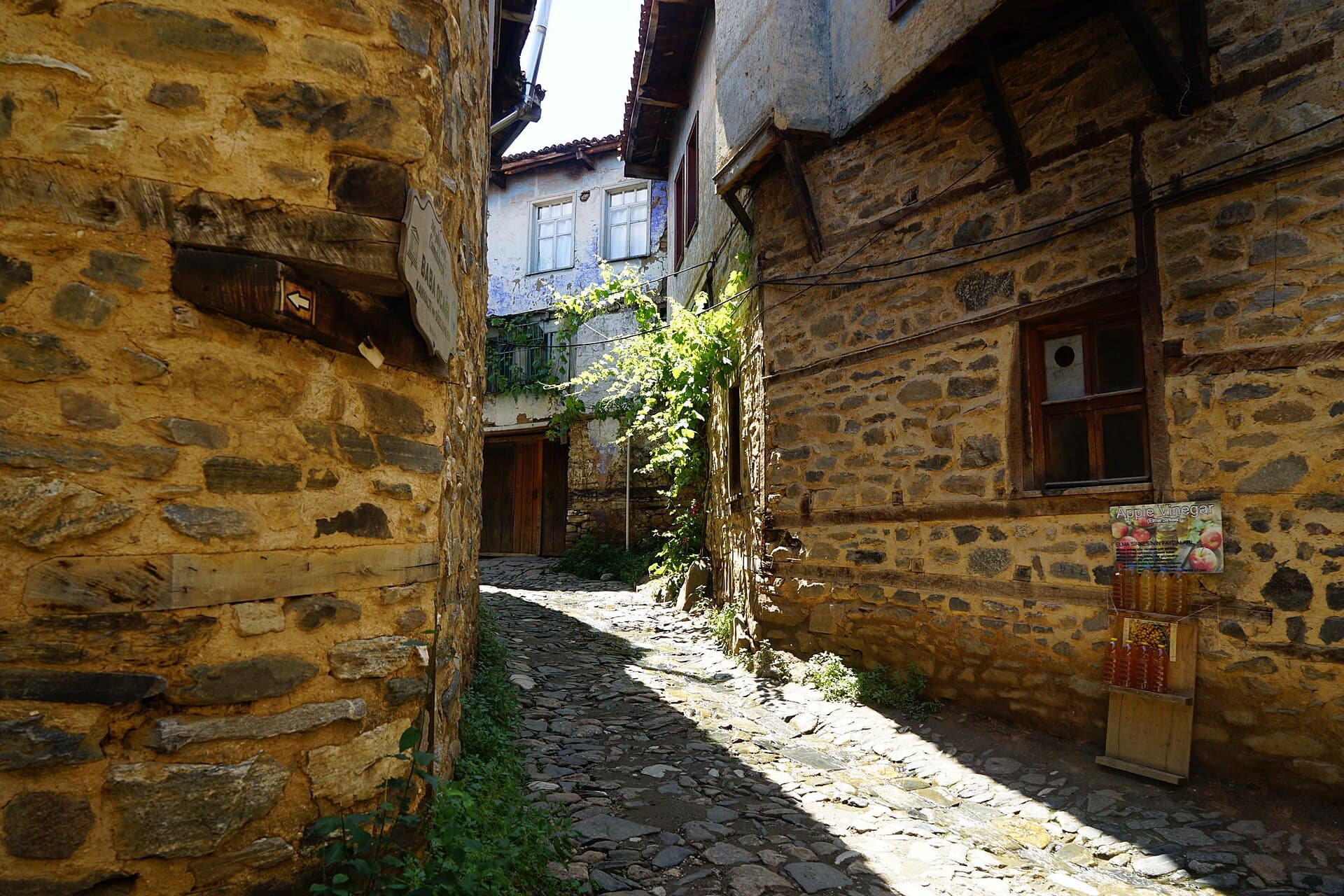 Narrow cobbled lane between timber-and-stone houses in Cumalıkızık village, Bursa.