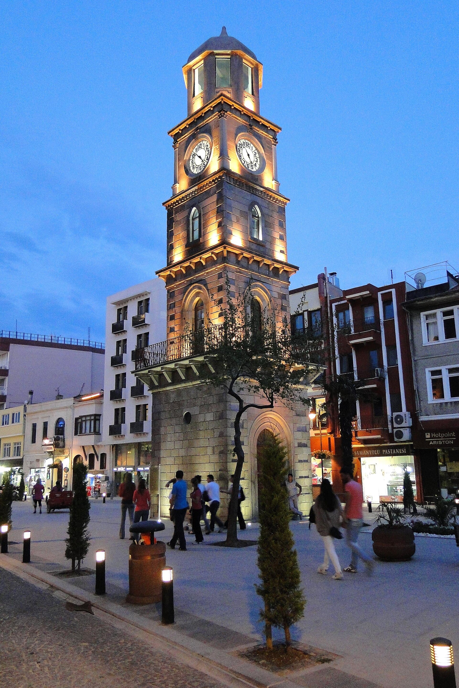 Illuminated 1897 Ottoman clock tower glowing at dusk in central Çanakkale