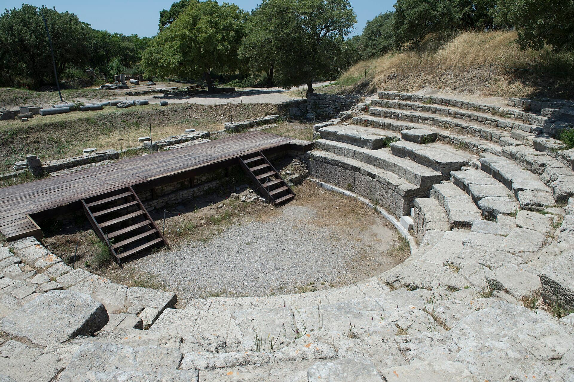 Curved stone seating rows of the small Roman odeon at ancient Troy