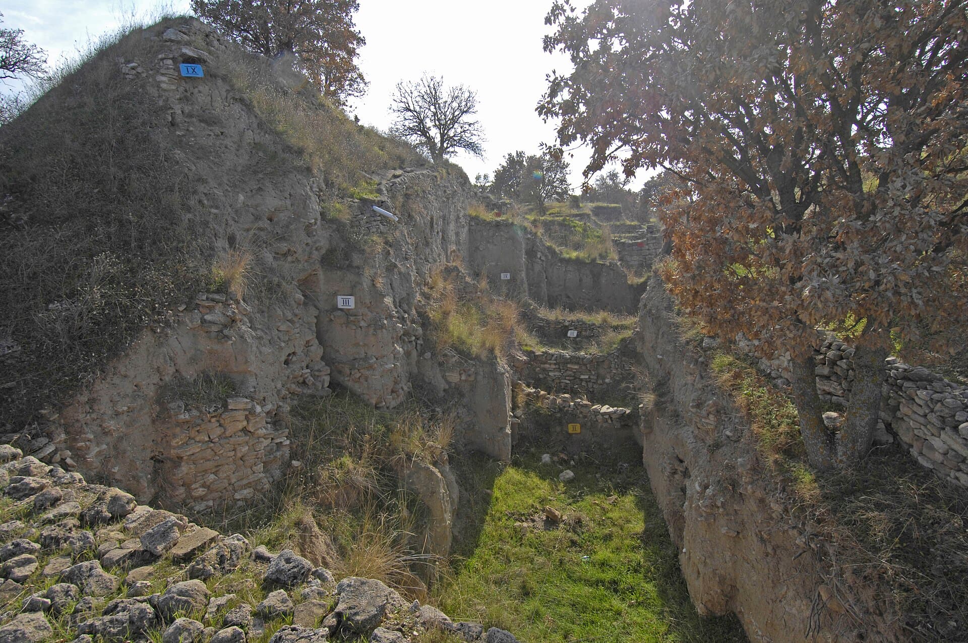 Schliemann's Trench at Troy, earthen walls banded with numbered ancient layers
