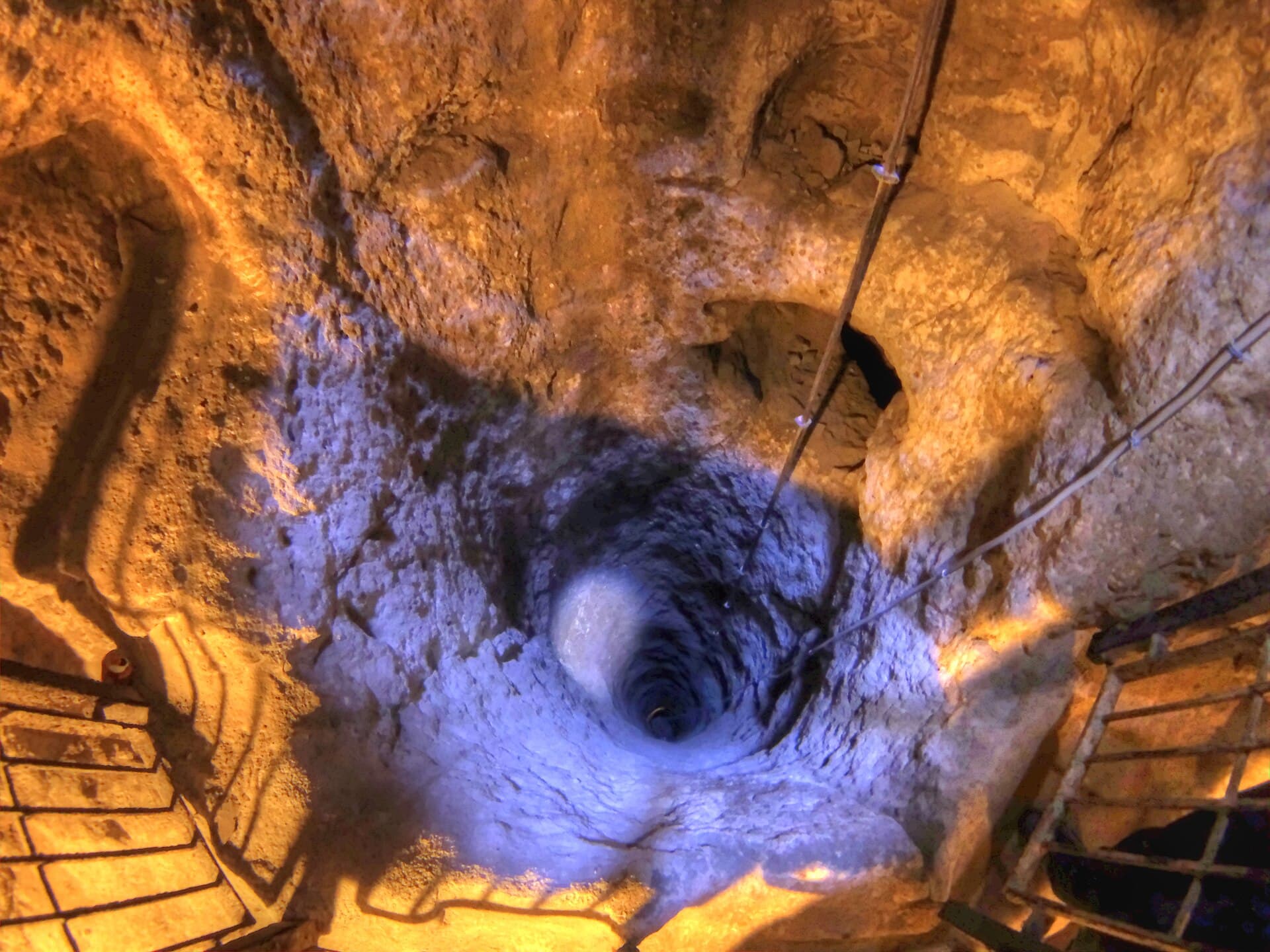 Looking down a deep ventilation shaft cut through volcanic rock at Derinkuyu Underground City