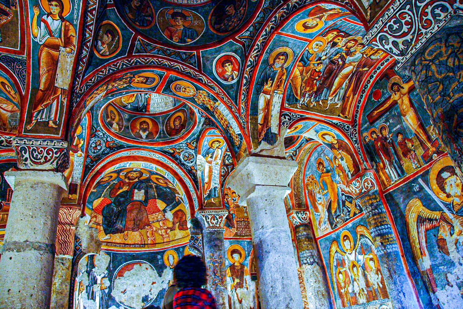 Byzantine frescoes of Christ, saints, and the Crucifixion painted across the ceiling and apse of the Dark Church at Göreme Open Air Museum