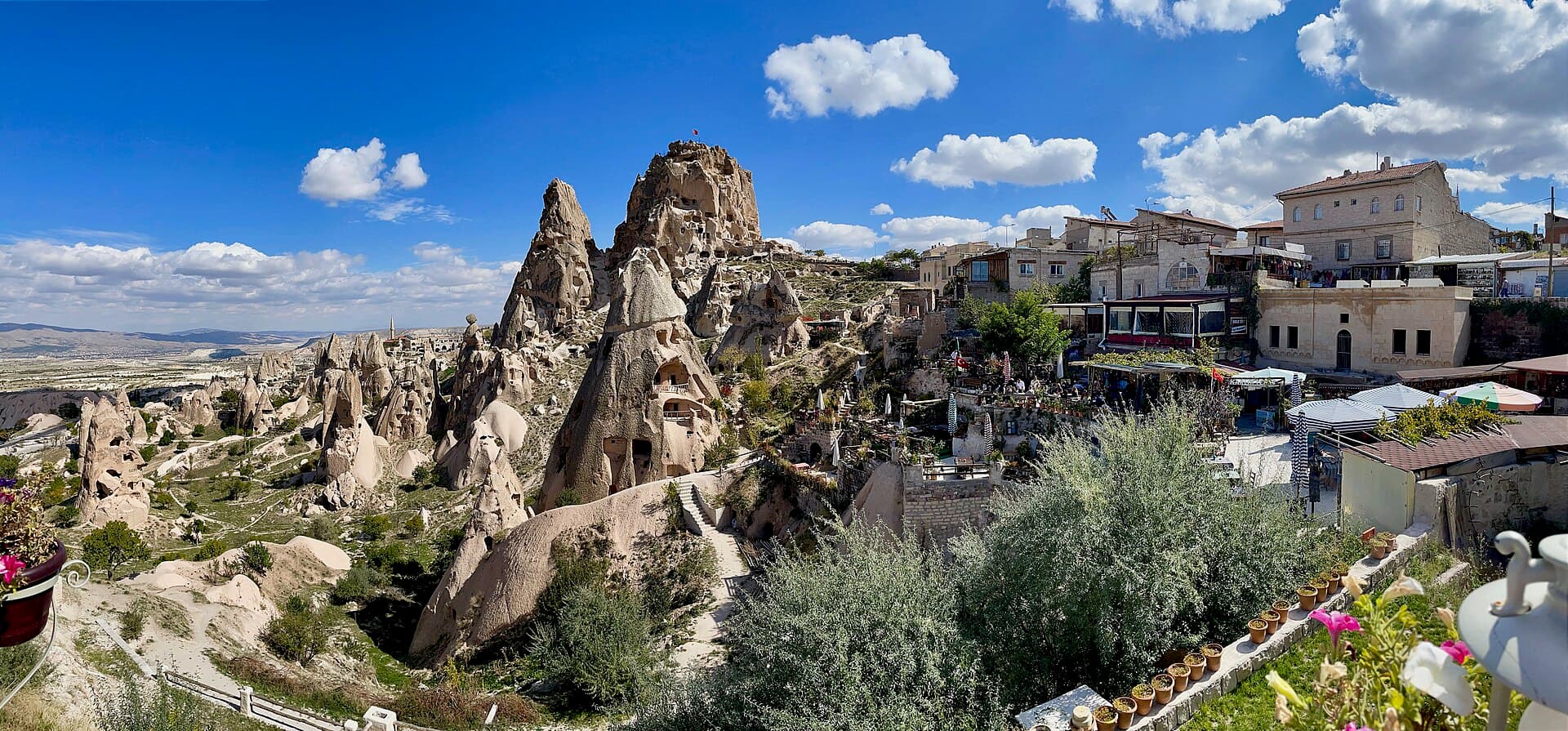 Uçhisar Castle rising above the town, surrounded by the fairy chimneys of Göreme National Park
