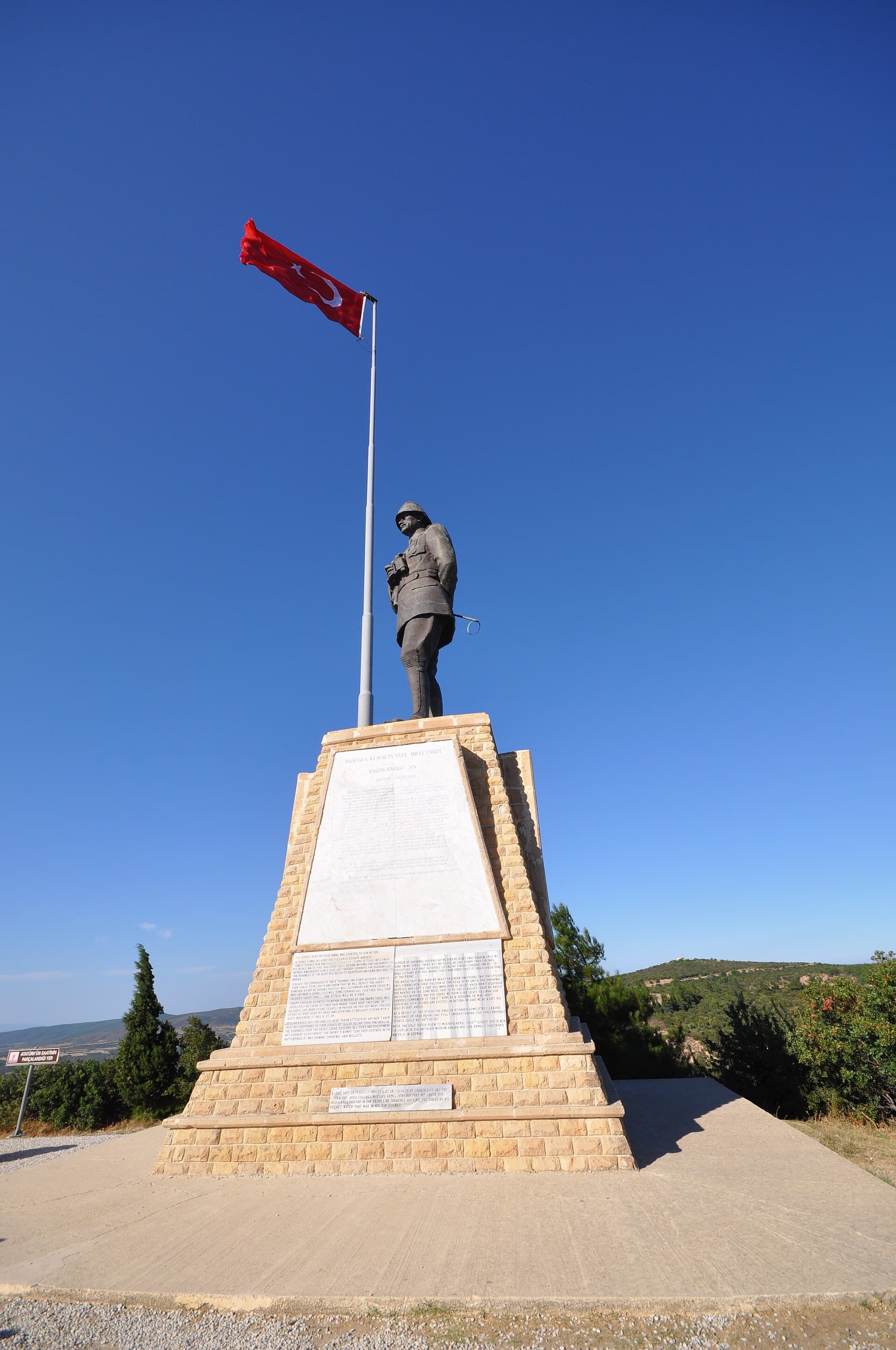 Bronze Atatürk statue on a stone pedestal with a Turkish flag, Chunuk Bair