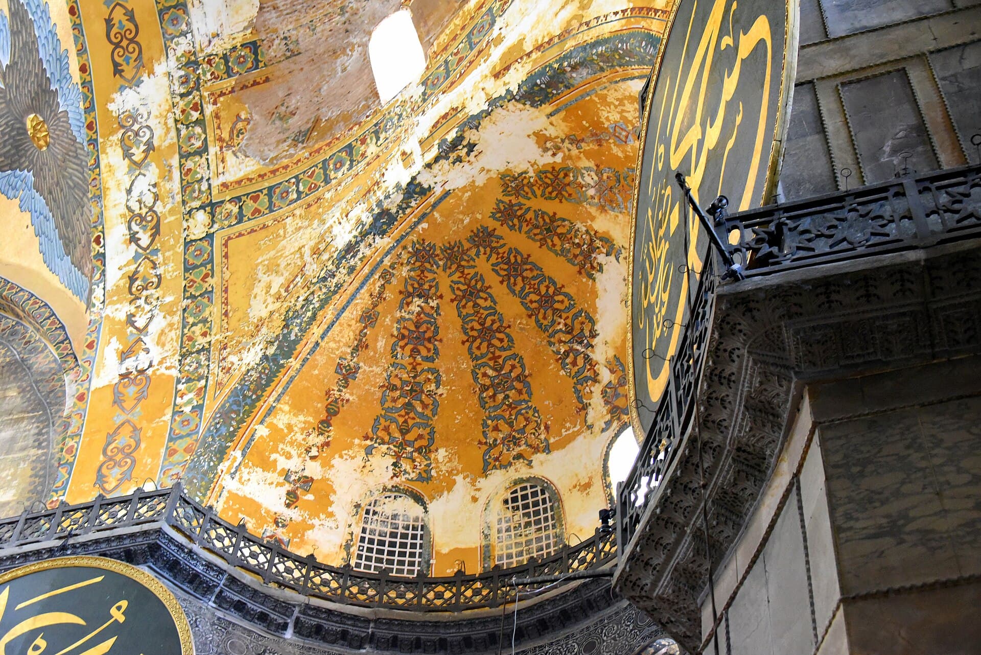 Gilded ceiling mosaics and a large calligraphy roundel beneath one of Hagia Sophia's interior domes