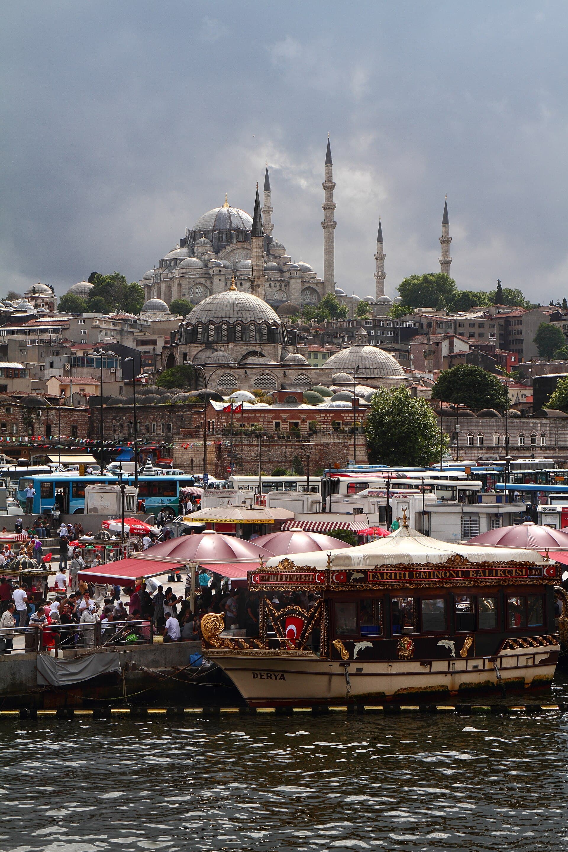 Süleymaniye Mosque's dome and minarets rising above the Istanbul skyline, viewed across the Golden Horn from Galata Bridge