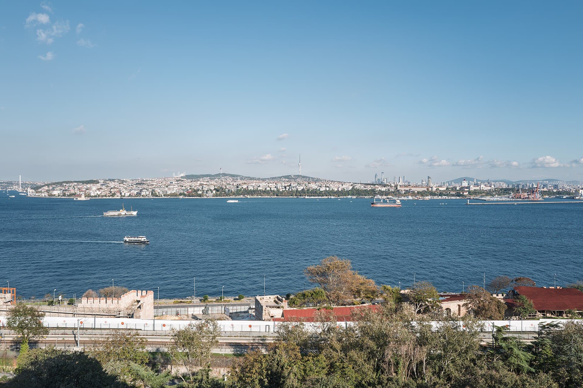 View of the Bosphorus and Istanbul's Asian shore from the grounds of Topkapı Palace, with ferries crossing the strait