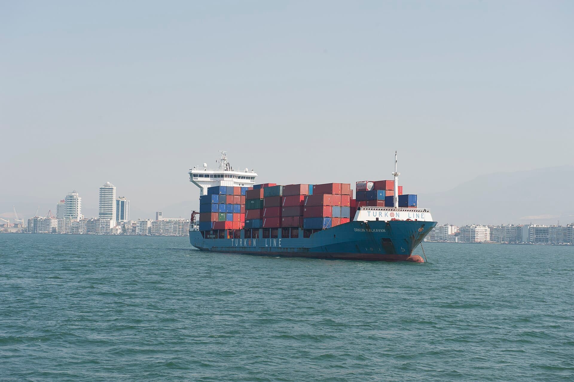 Passengers aboard the İzmir gulf ferry crossing toward Konak on a sunny day.