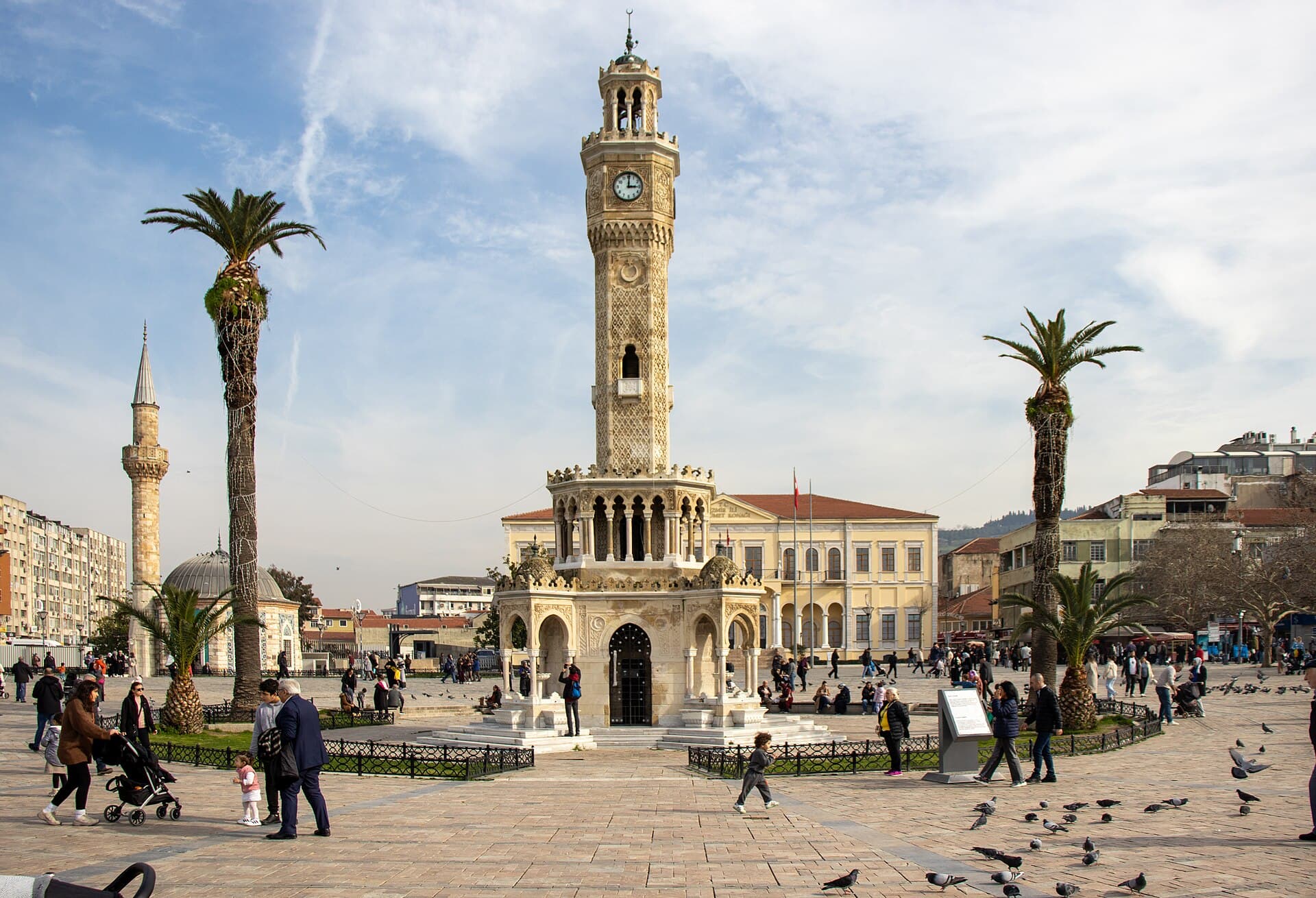 İzmir's marble Clock Tower in Konak Square under bright afternoon sunlight.