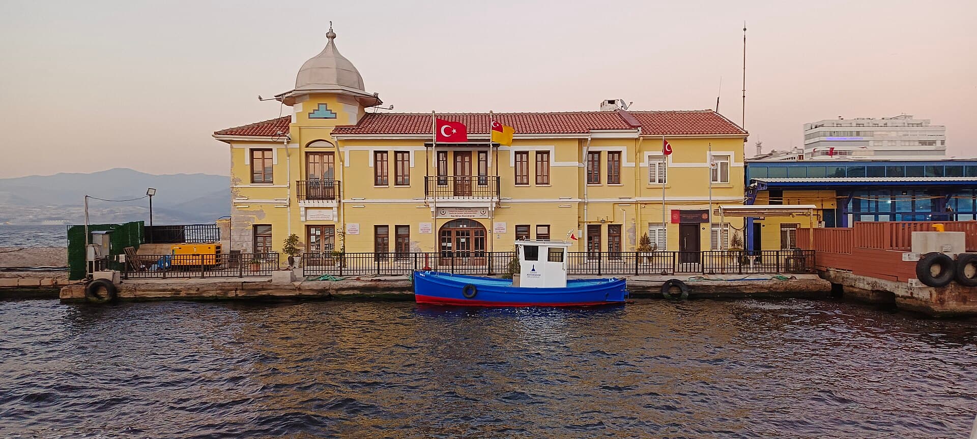 Pasaport ferry terminal building on the İzmir waterfront, daylight view.