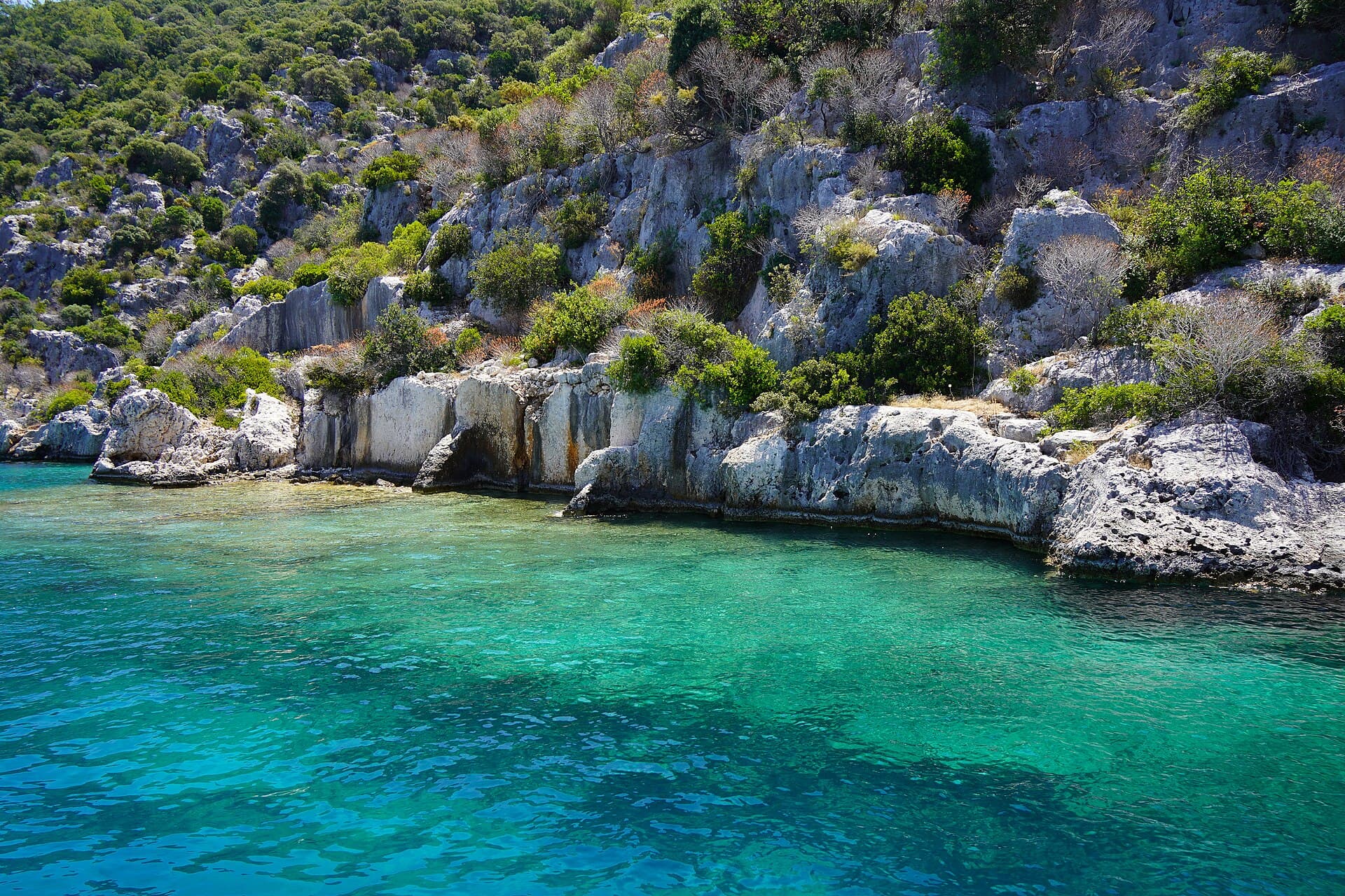 Submerged Lycian-Roman ruins visible beneath clear turquoise water at Kekova's sunken city.