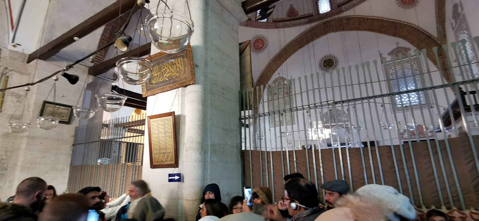 Octagonal semahane hall at Mevlana Museum with Mevlevi ceremonial display cases.