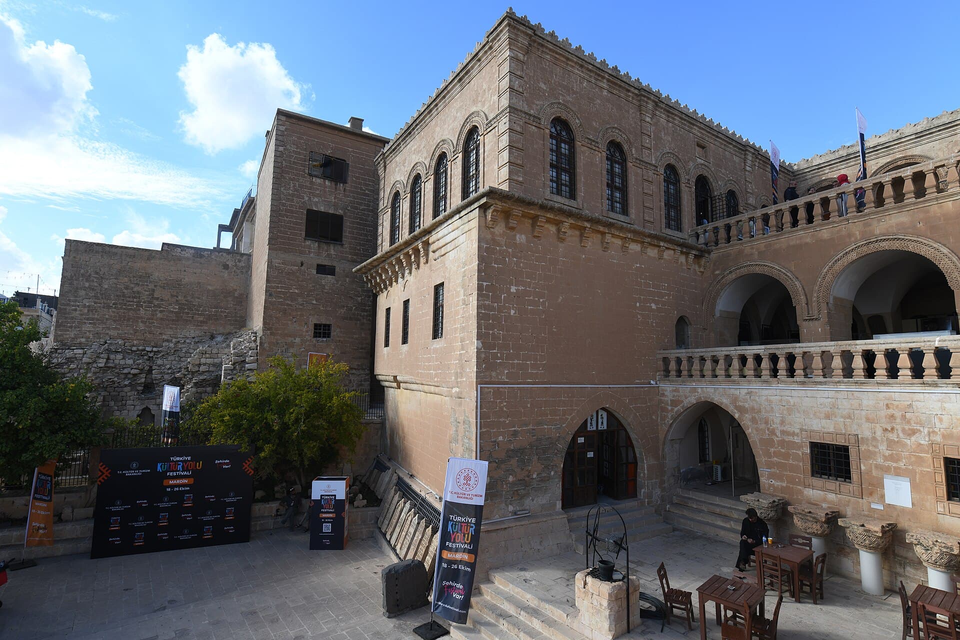 Exterior corner of Mardin Museum with carved stone windows and cornice.