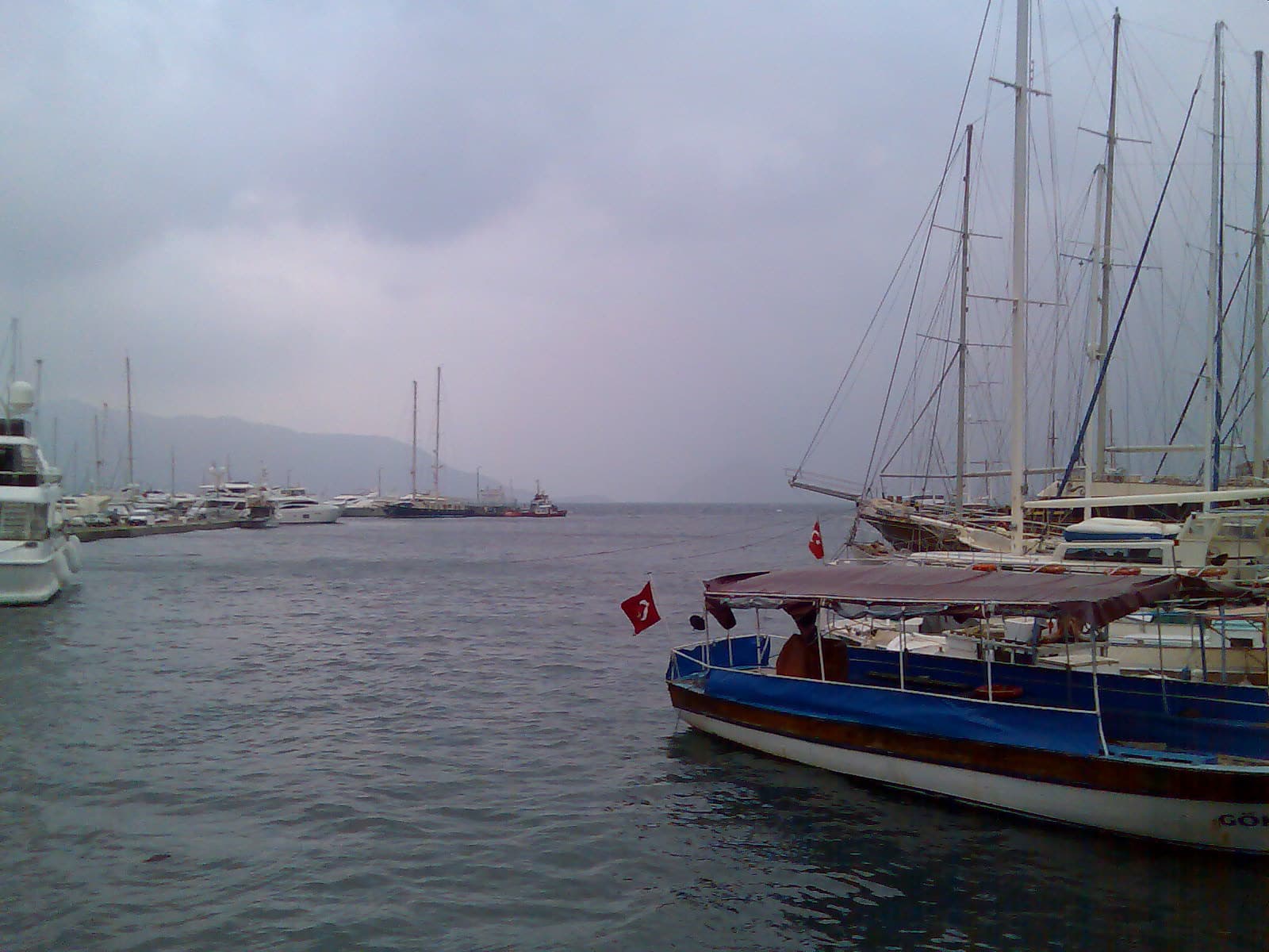 A two-masted wooden gulet moored among yachts at Netsel Marina, Marmaris.