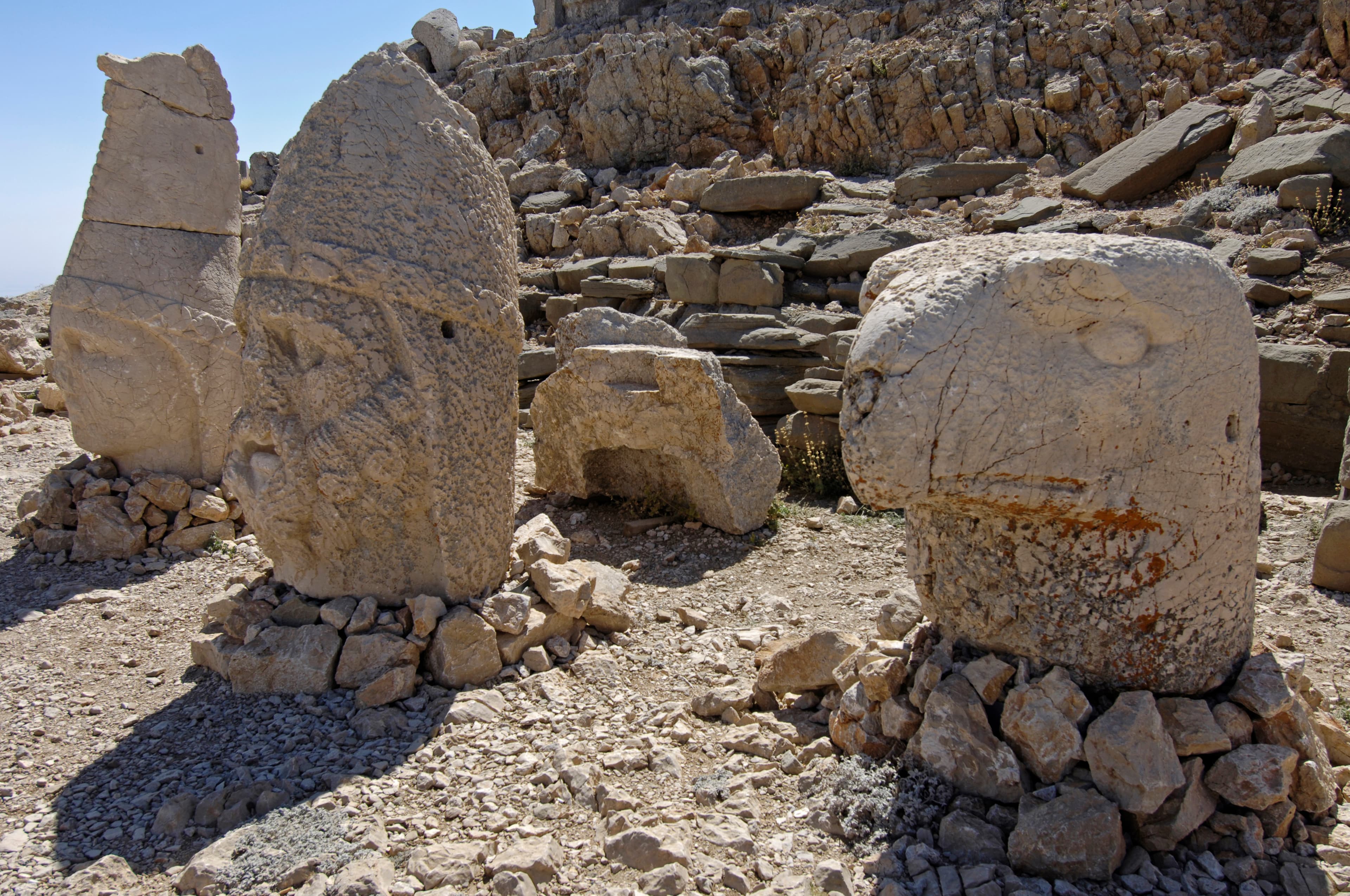 Row of colossal weathered stone heads on rubble at Mount Nemrut's East Terrace summit