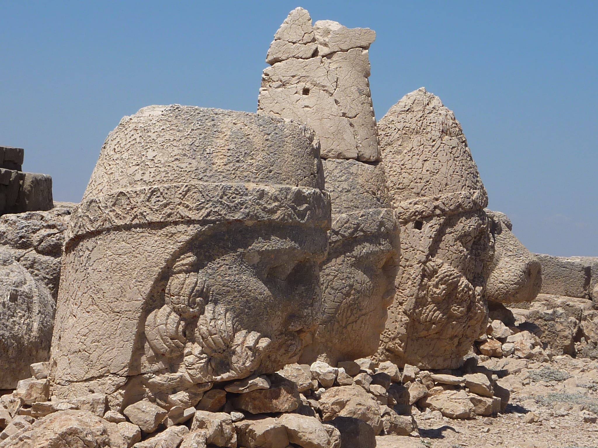 Close-up of two colossal carved stone heads at Mount Nemrut's East Terrace summit