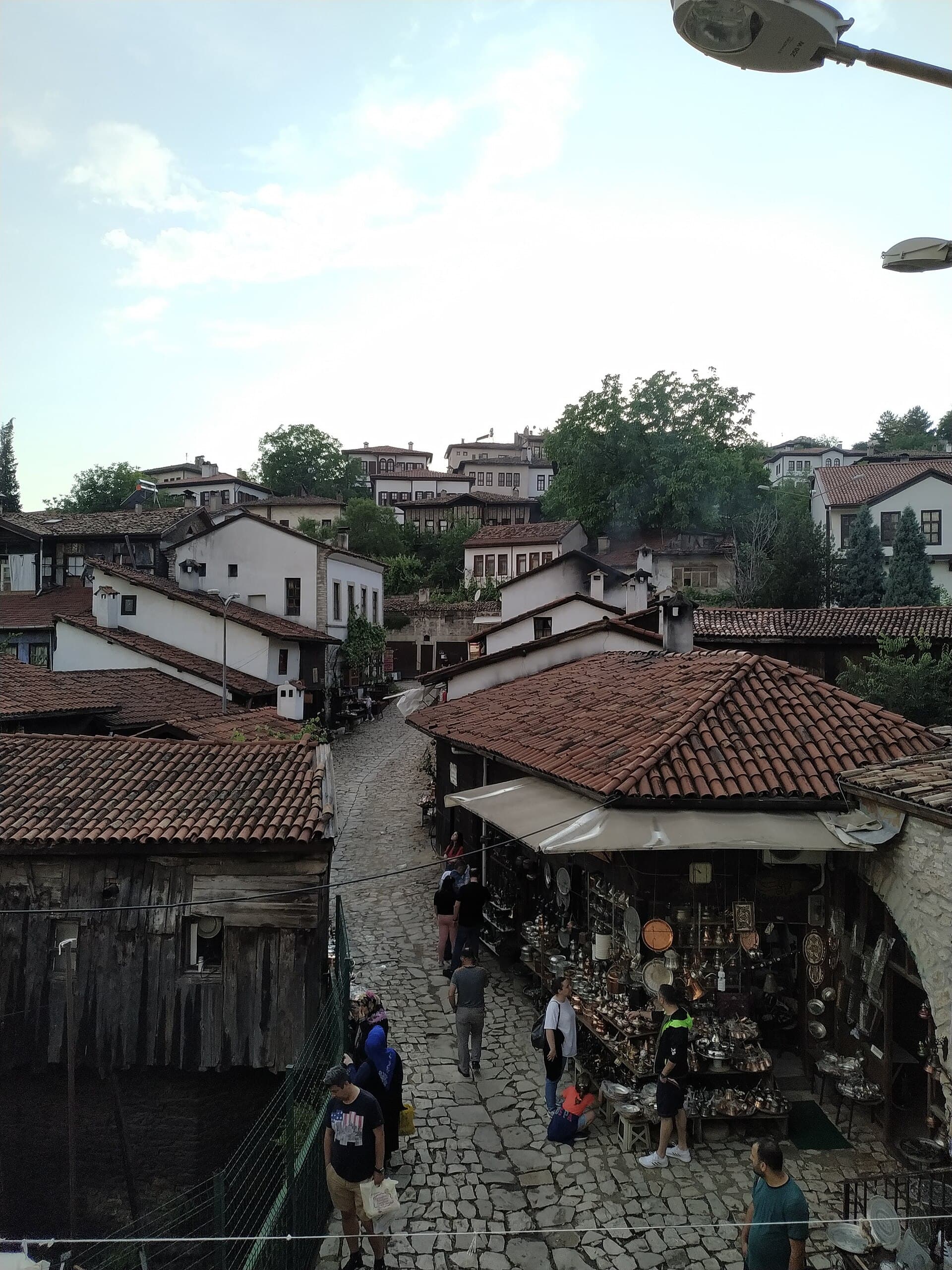 Narrow Safranbolu bazaar lane lined with dark timber-framed Ottoman house facades.