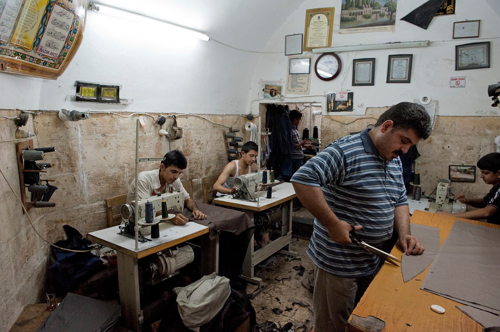 Historic han courtyard with workshops and tea tables, Şanlıurfa bazaar.