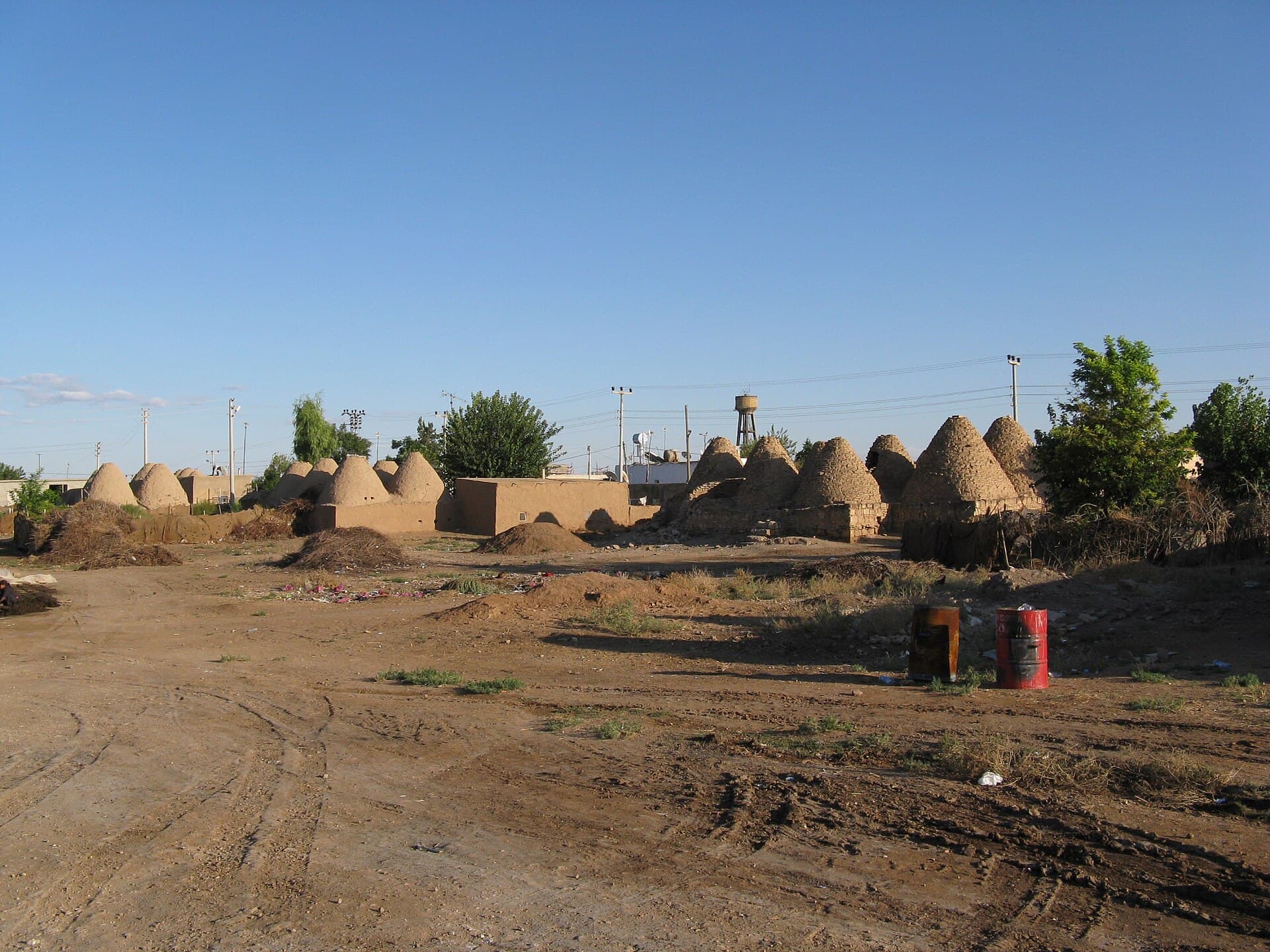 Sunlit row of Harran's distinctive conical beehive mudbrick houses.