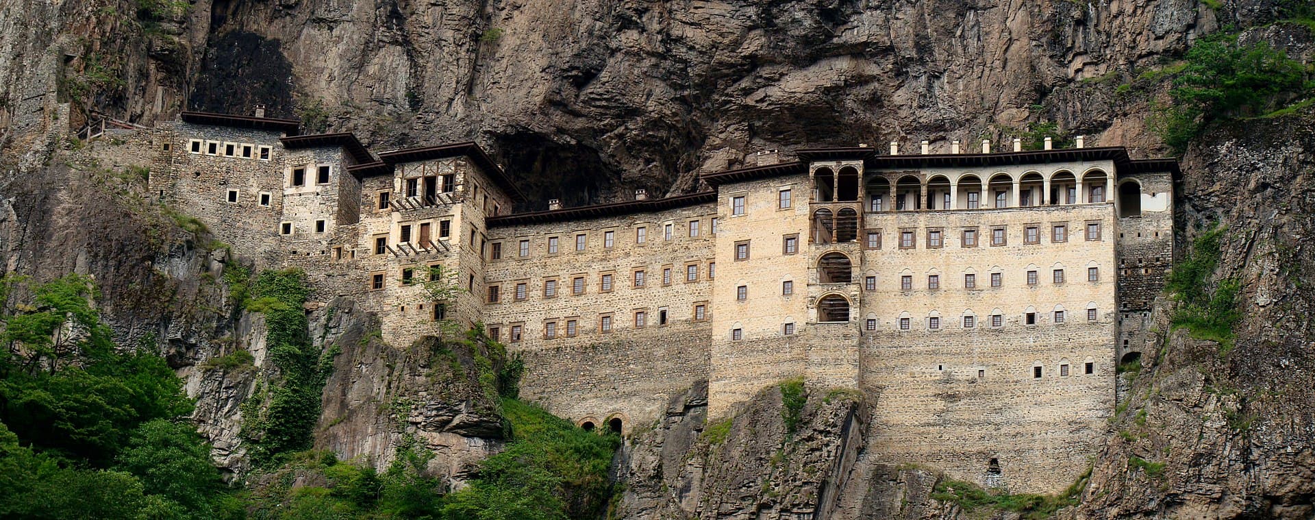 Sümela Monastery's multi-storey building built into a sheer cliff, seen across the valley