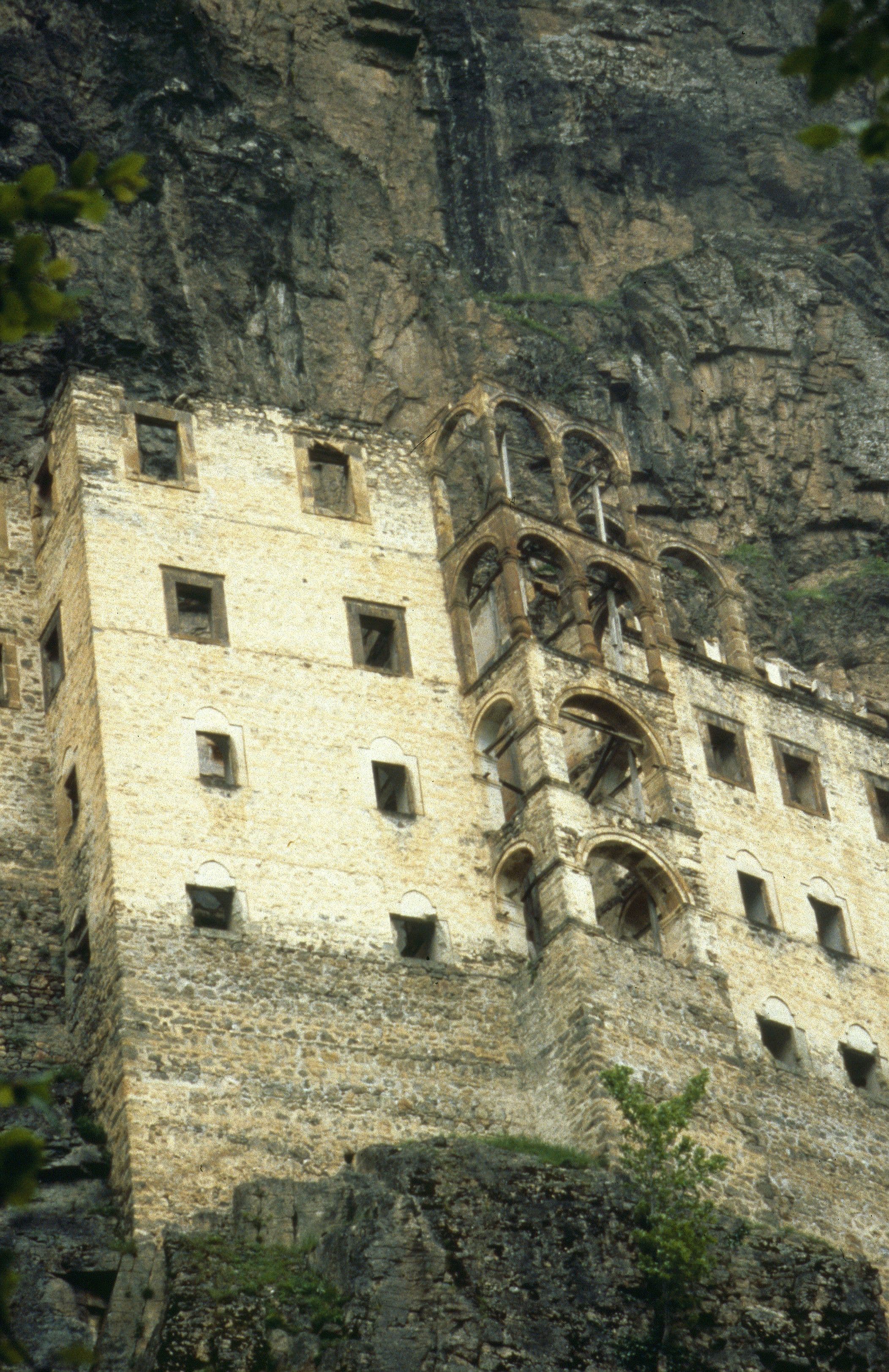 Close view of Sümela Monastery's stacked stone facade and arched balcony against the cliff