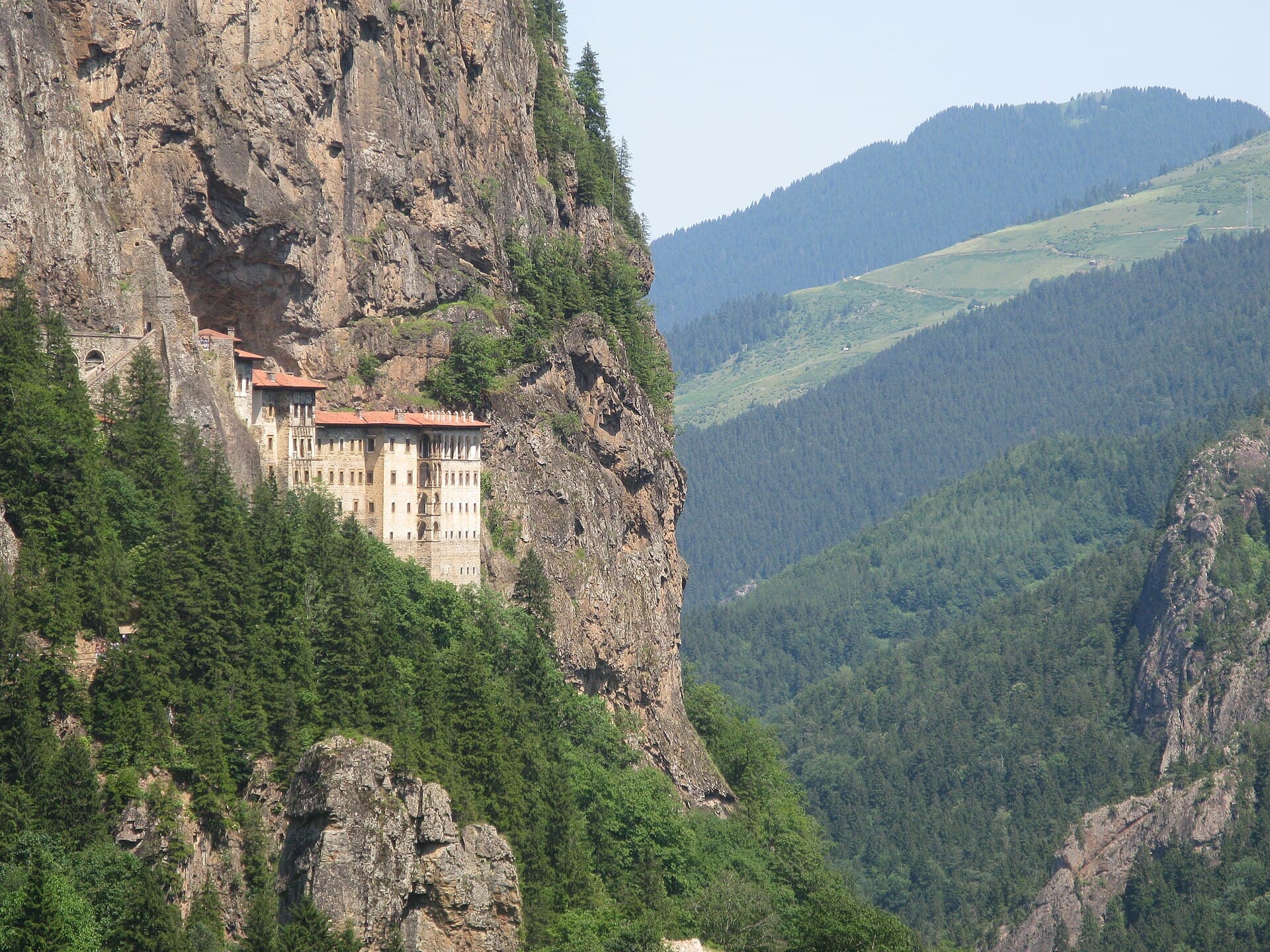 Sümela Monastery on a cliff face, with the forested Altındere valley stretching beside it